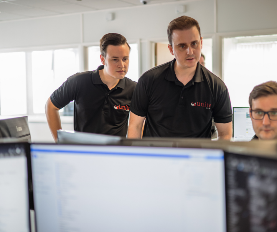 3 cyber essentials assessors looing at computer screen