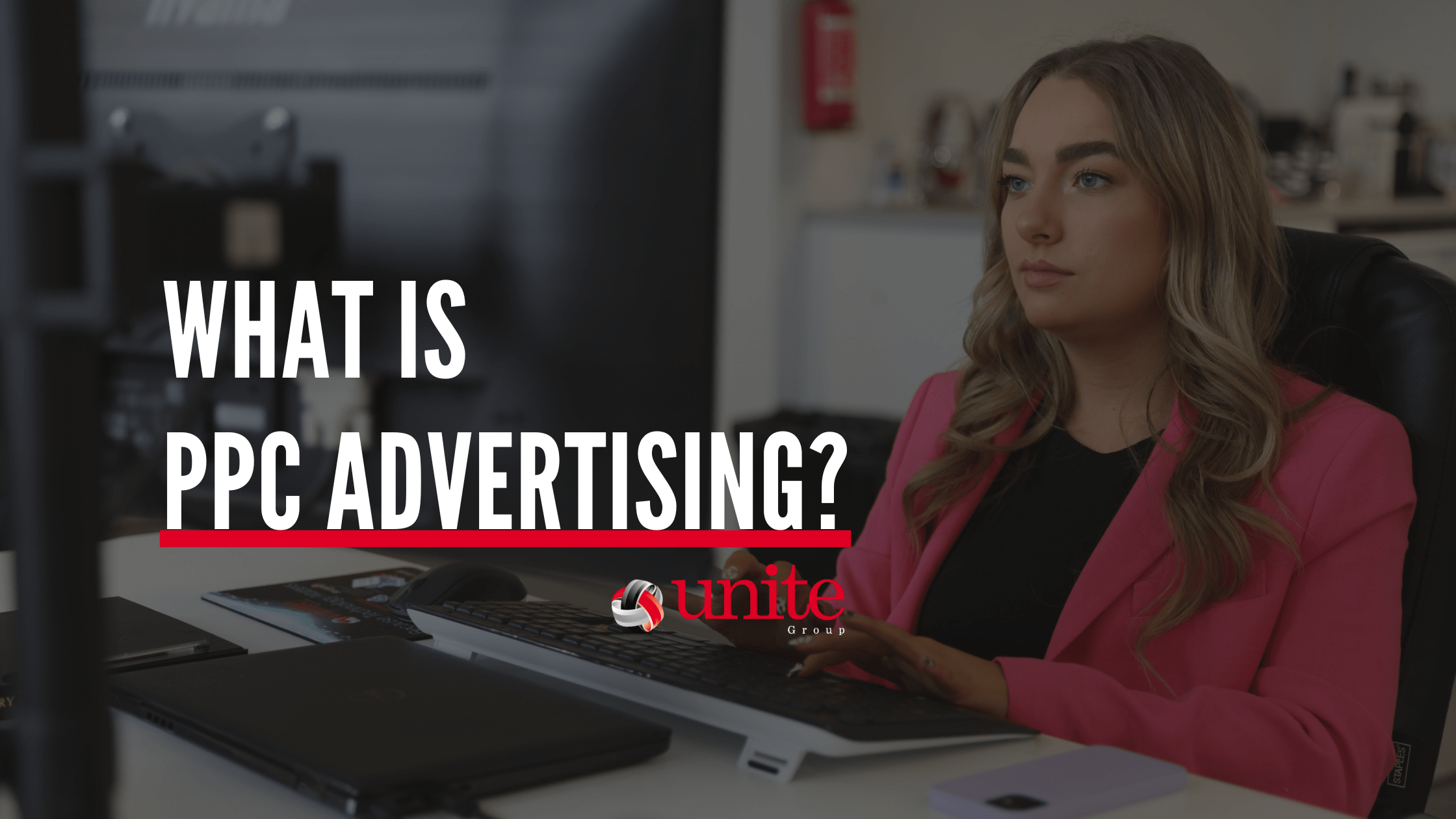 PPC Advertising banner with a woman typing at a desk in a smart blazer.